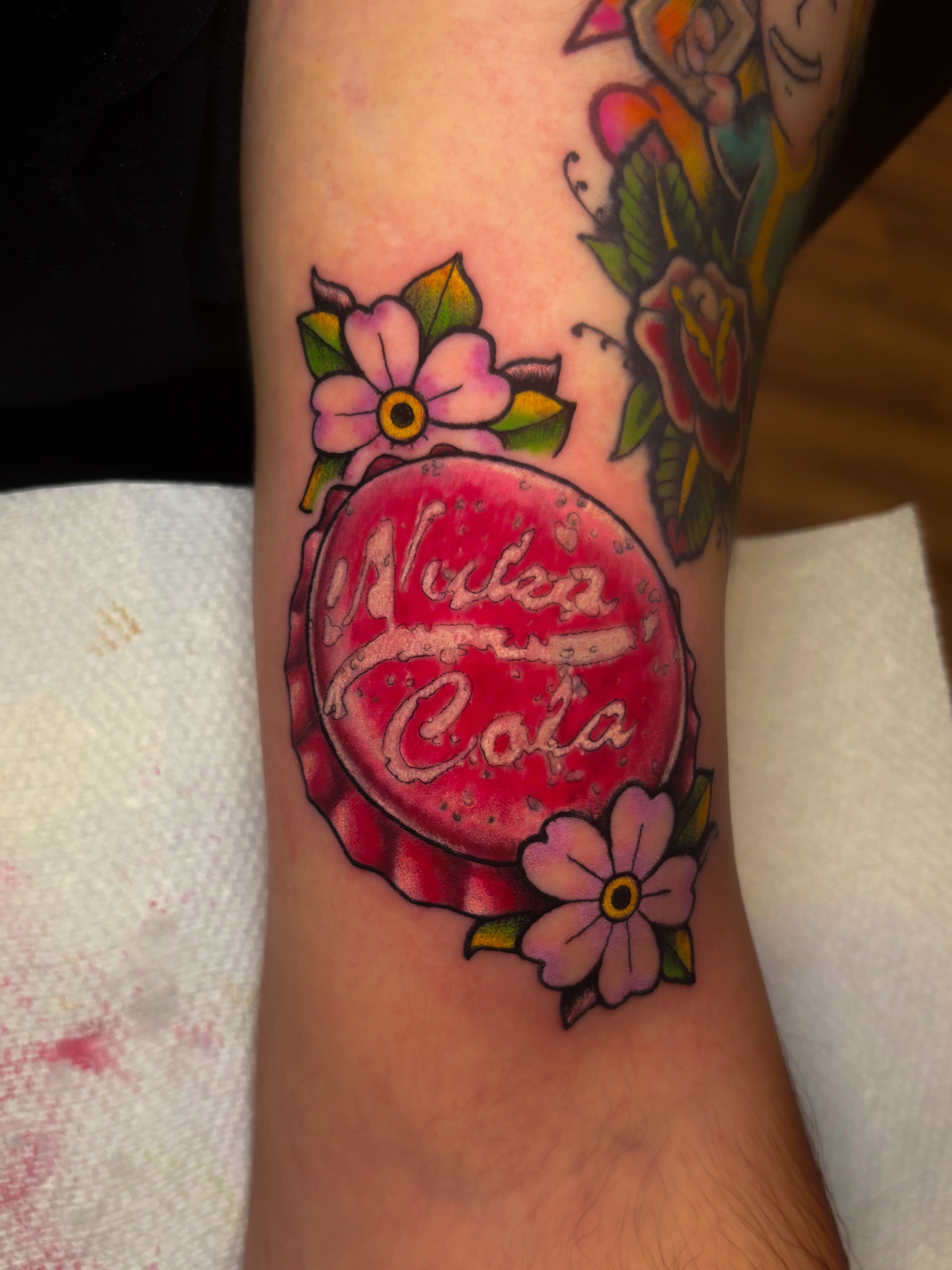 Nuka cola bottle cap American traditional tattoo on the forearm by Sal