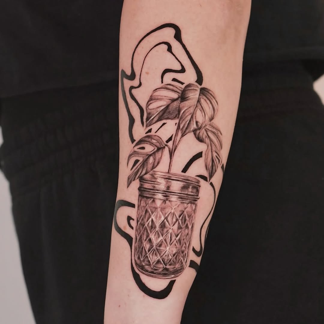 Monstera plant in a jar surrealism tattoo on the forearm by Longtea