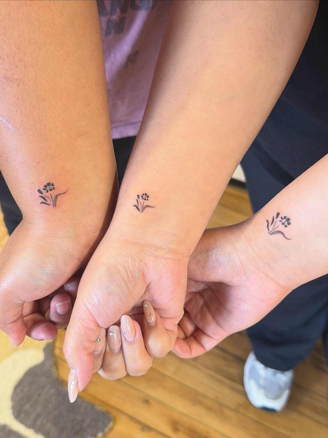 Small floral design minimalist tattoo on the forearm by Sienna (jj) Hicks