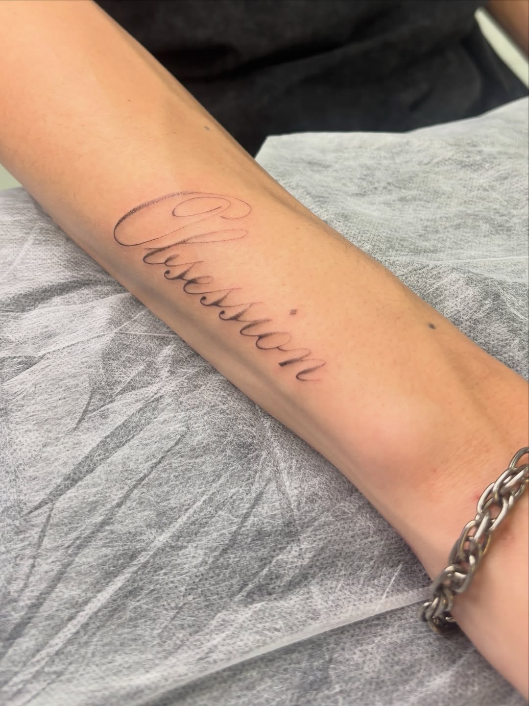Script lettering lettering tattoo on the forearm by ꜱʜɪʀʟᴇʏ