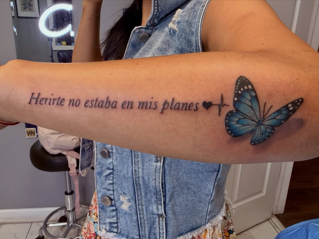 Butterfly and text fine line tattoo on the forearm by linda perez