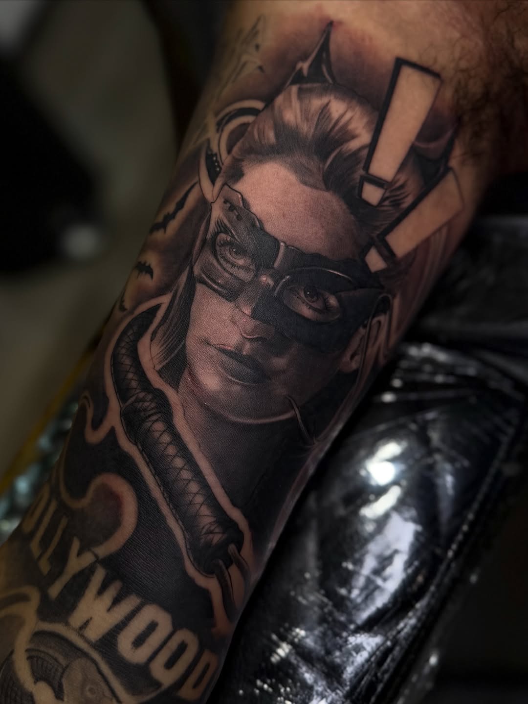 Catwoman portrait with Hollywood sign realism tattoo on the forearm by San Diego Tattoo Artist