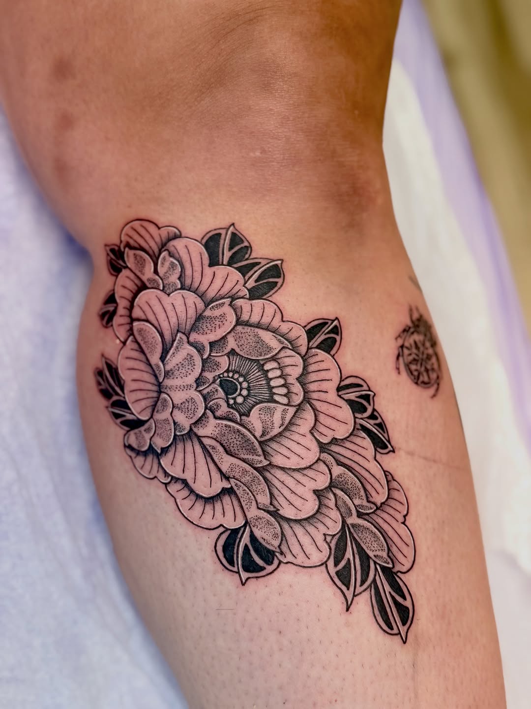 Peony flower dotwork tattoo on the thigh by Ink About Me - Amanda’s Fine Lines