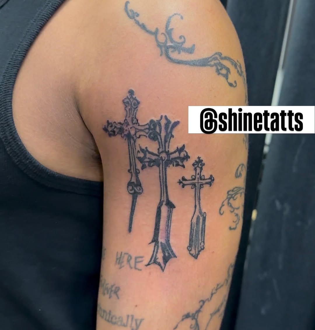 Three crosses blackwork tattoo on the upper arm by Shine Jefferson, Memphis, Tennessee