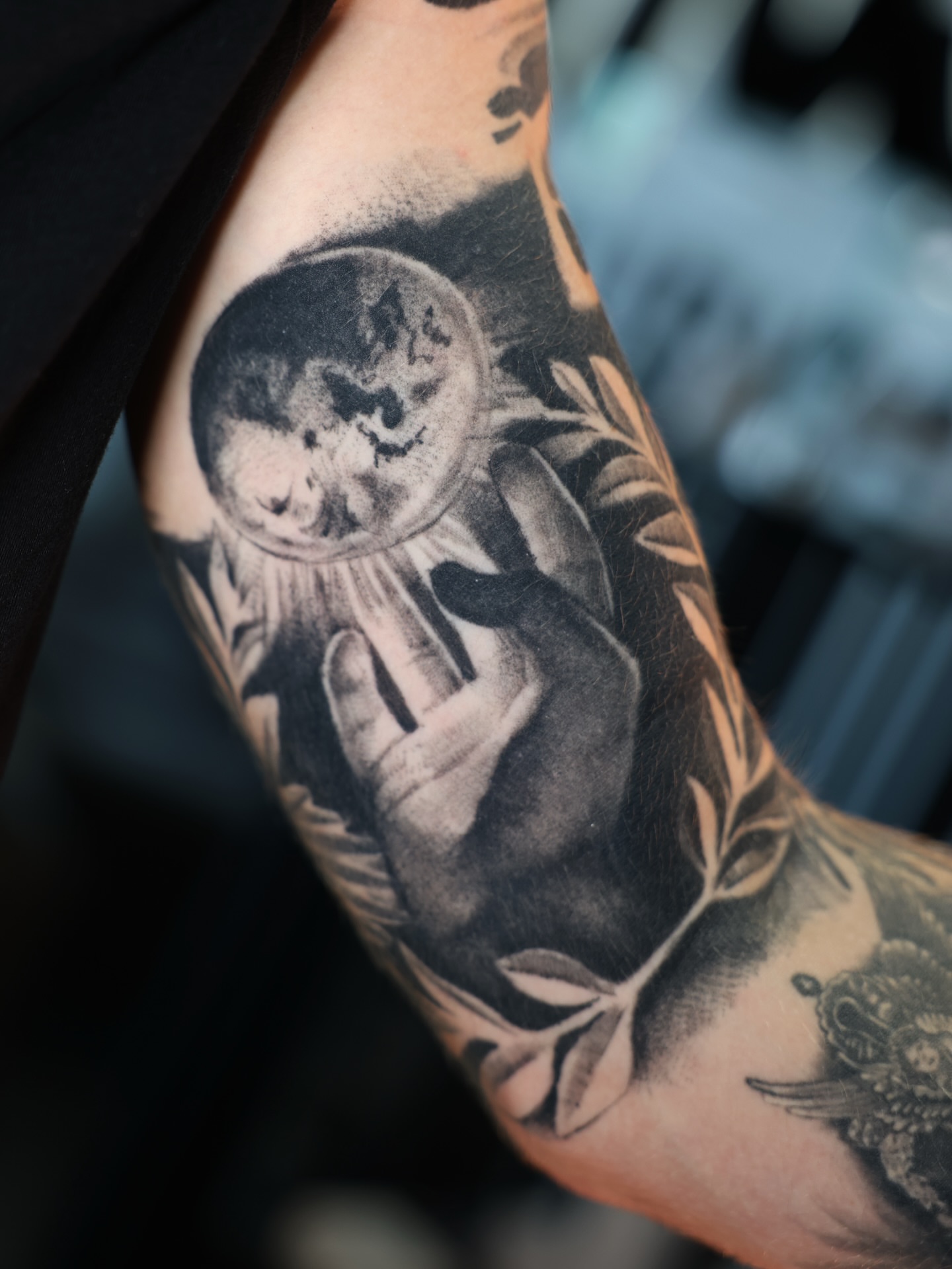 Moon and hand realism tattoo on the forearm by Absolute