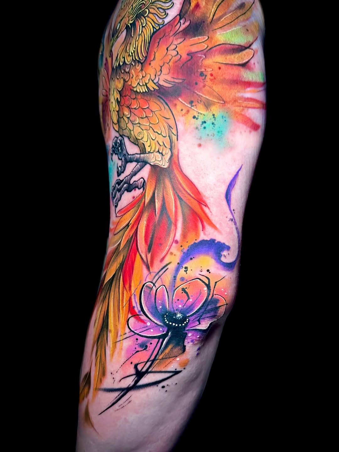 Phoenix and flower watercolor tattoo on the forearm by Alena Petunia