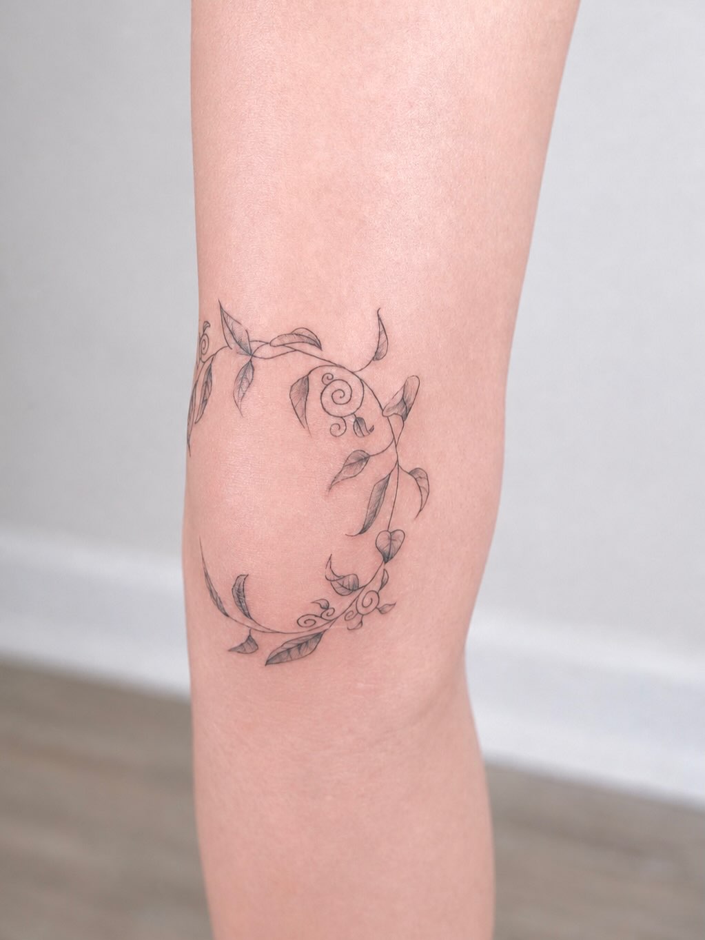 Vine with leaves and flowers cyber sigilism tattoo on the forearm by Elana Hites