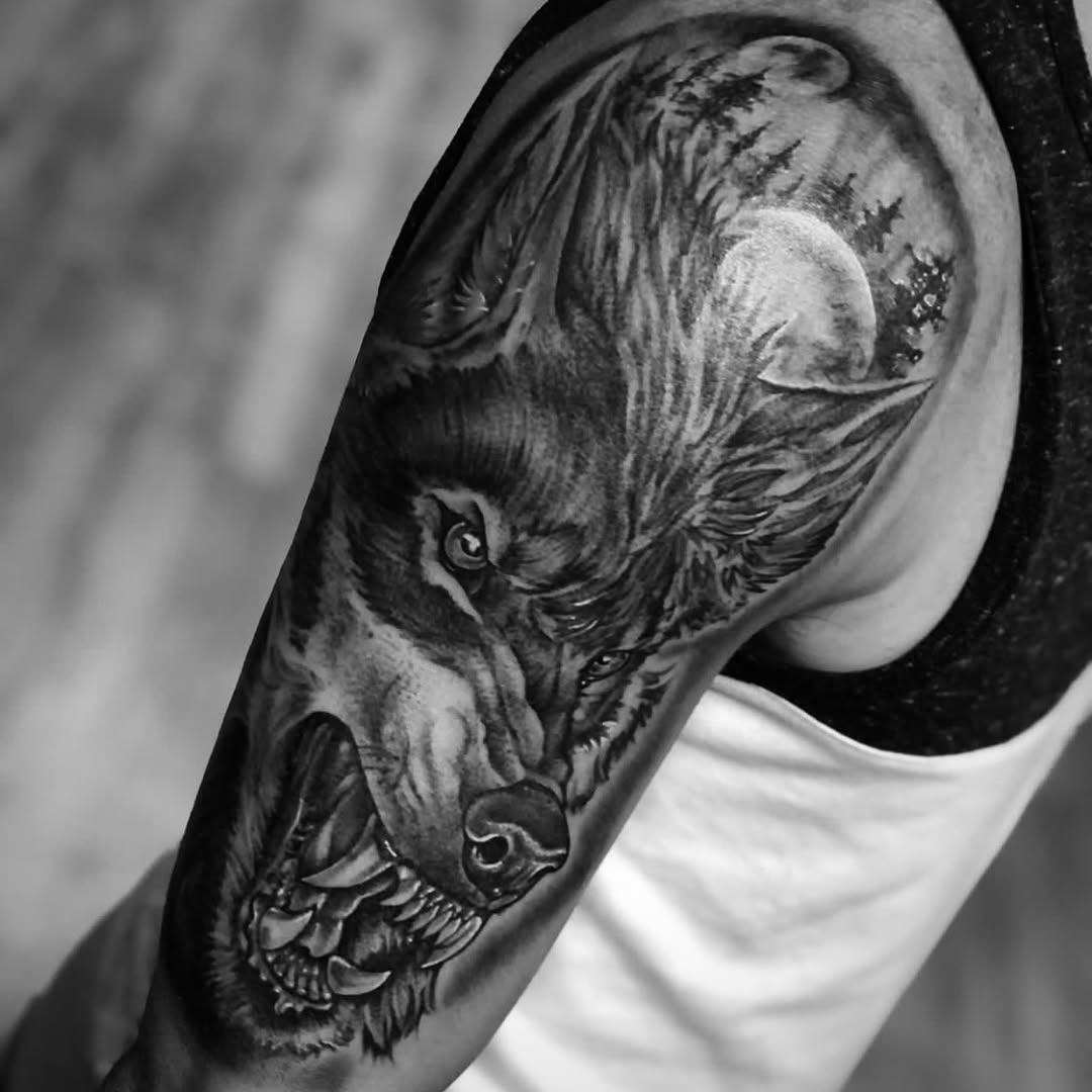 Wolf head with moon and forest realism tattoo on the forearm by Big Steve Lewis
