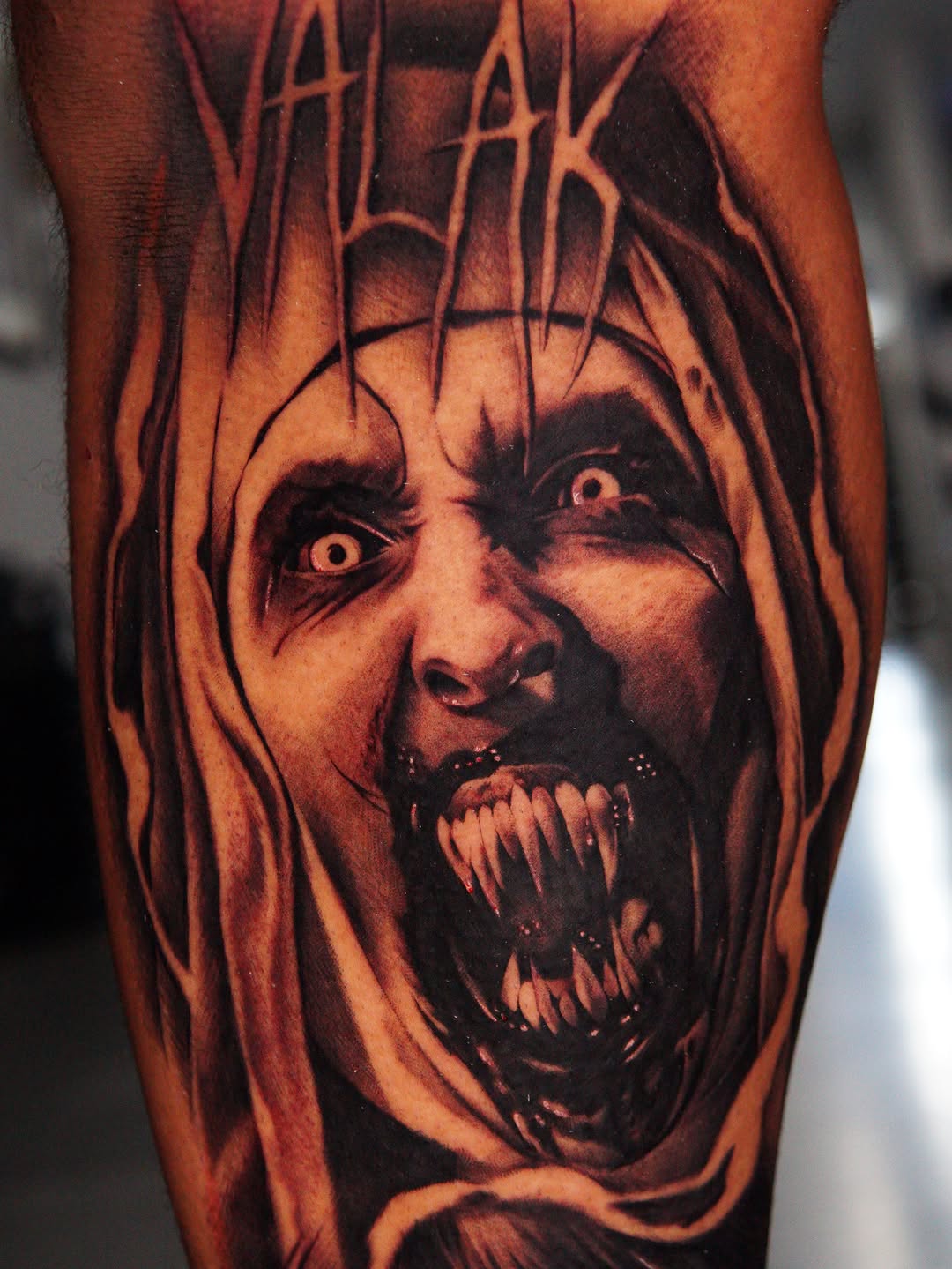 Demonic face with fangs realism tattoo on the forearm by Atlanta Tattoo Artist, Atlanta, Georgia