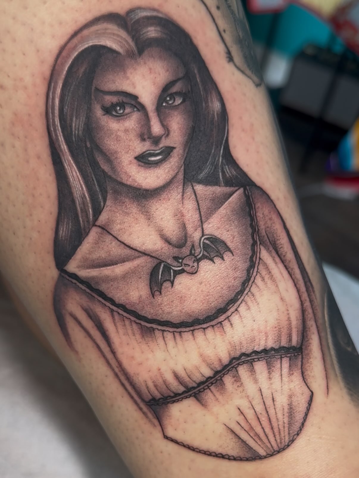 Woman with bat necklace realism tattoo on the thigh by H e I D I