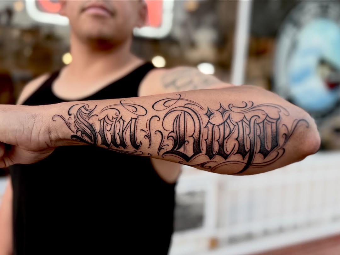 Script lettering lettering tattoo on the forearm by Barbara Gonzalez