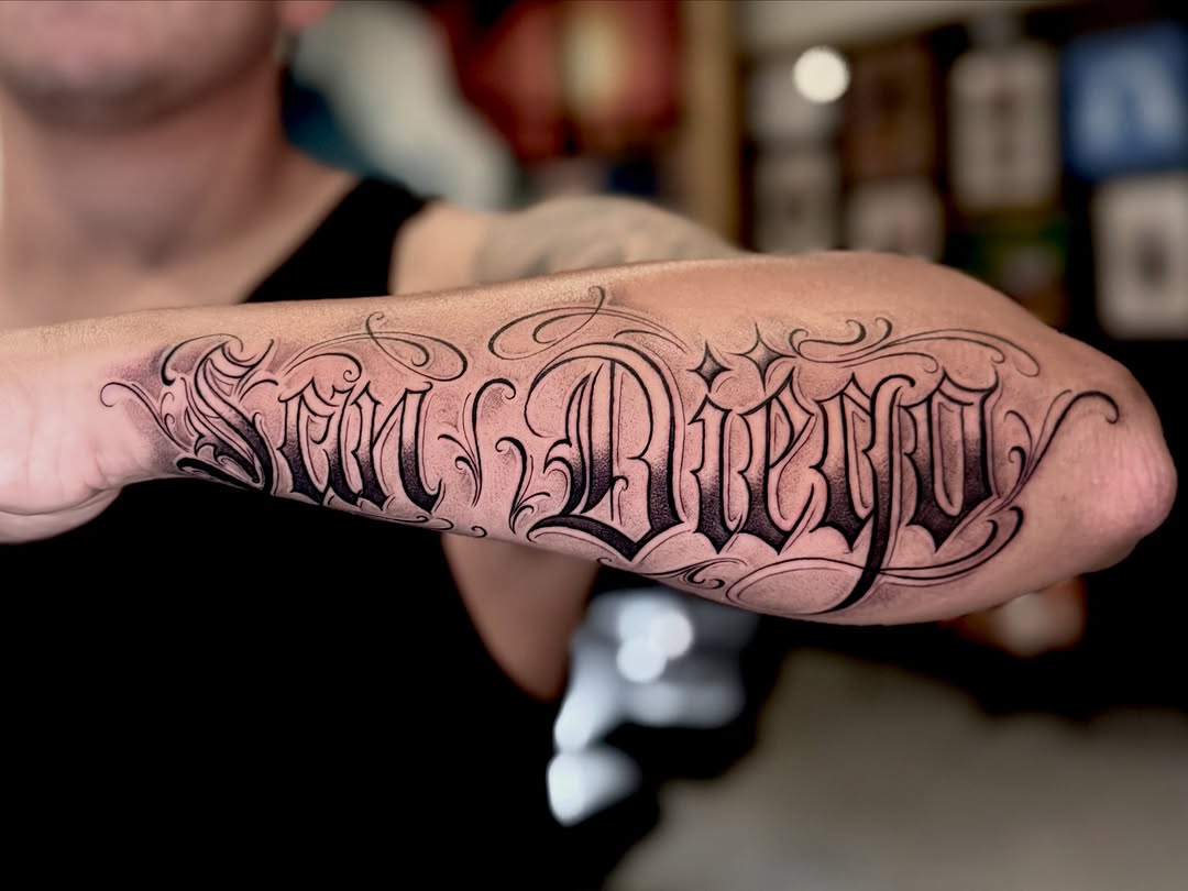 Script lettering lettering tattoo on the forearm by Barbara Gonzalez