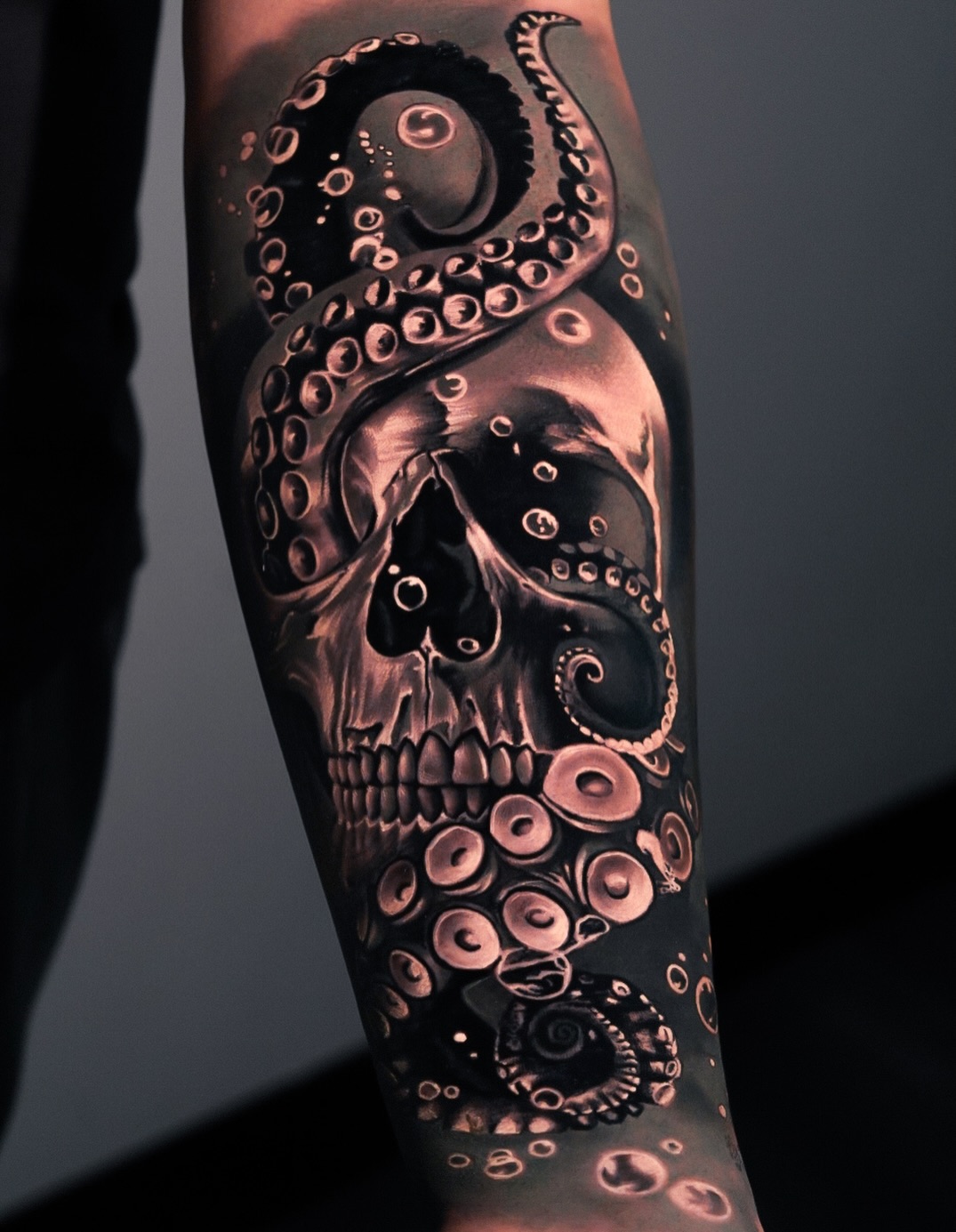 Skull and octopus tentacles dark art tattoo on the forearm by George Lange