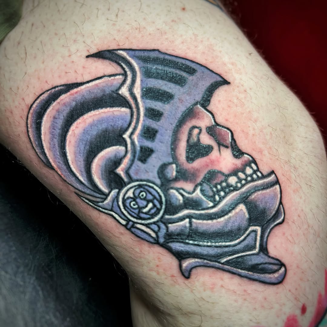 Skull in helmet dark art tattoo on the thigh by Anthony Guido