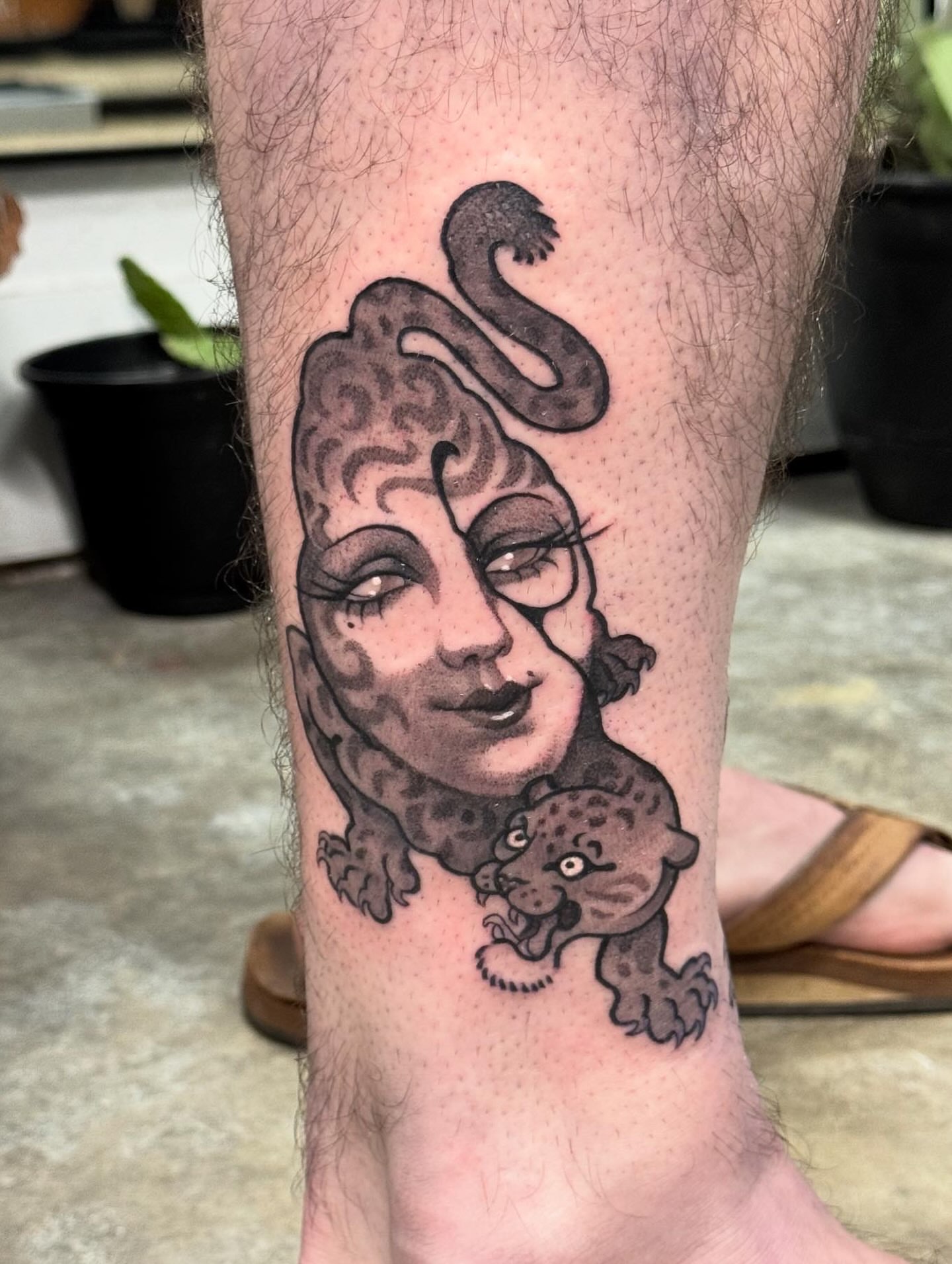 Woman with leopard realism tattoo on the calf by Marina Spell