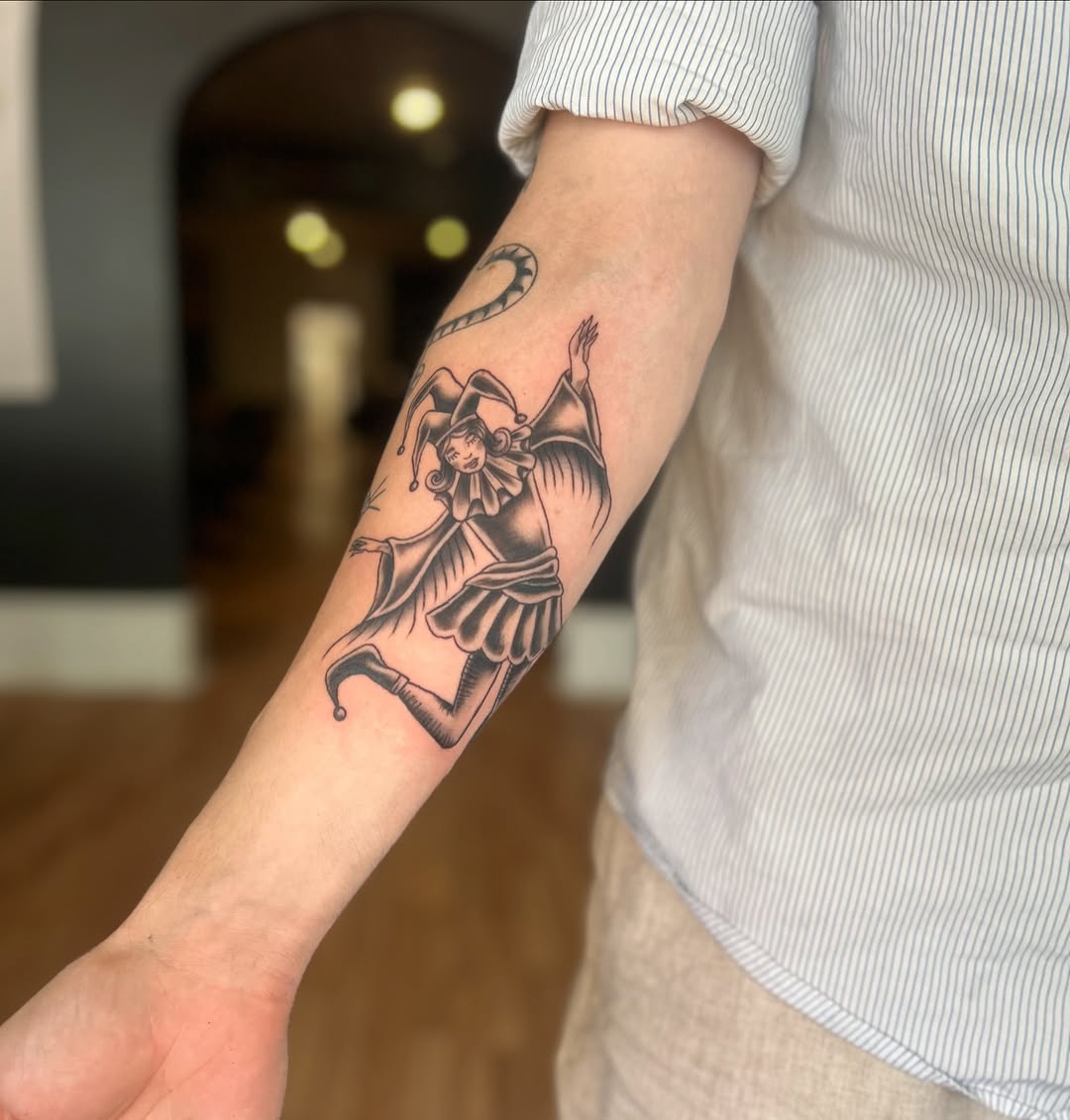 Jester realism tattoo on the forearm by Tori Magill
