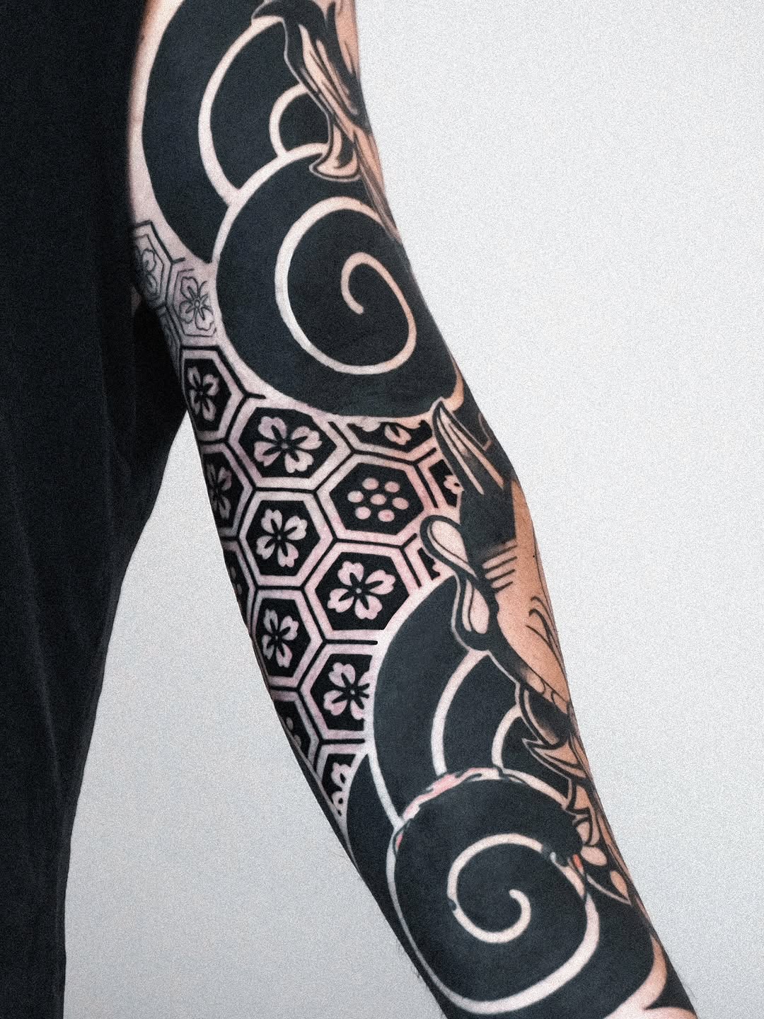 Waves and geometric pattern with flowers Japanese tattoo on the forearm by Jeremy "Jerms" Camposanto