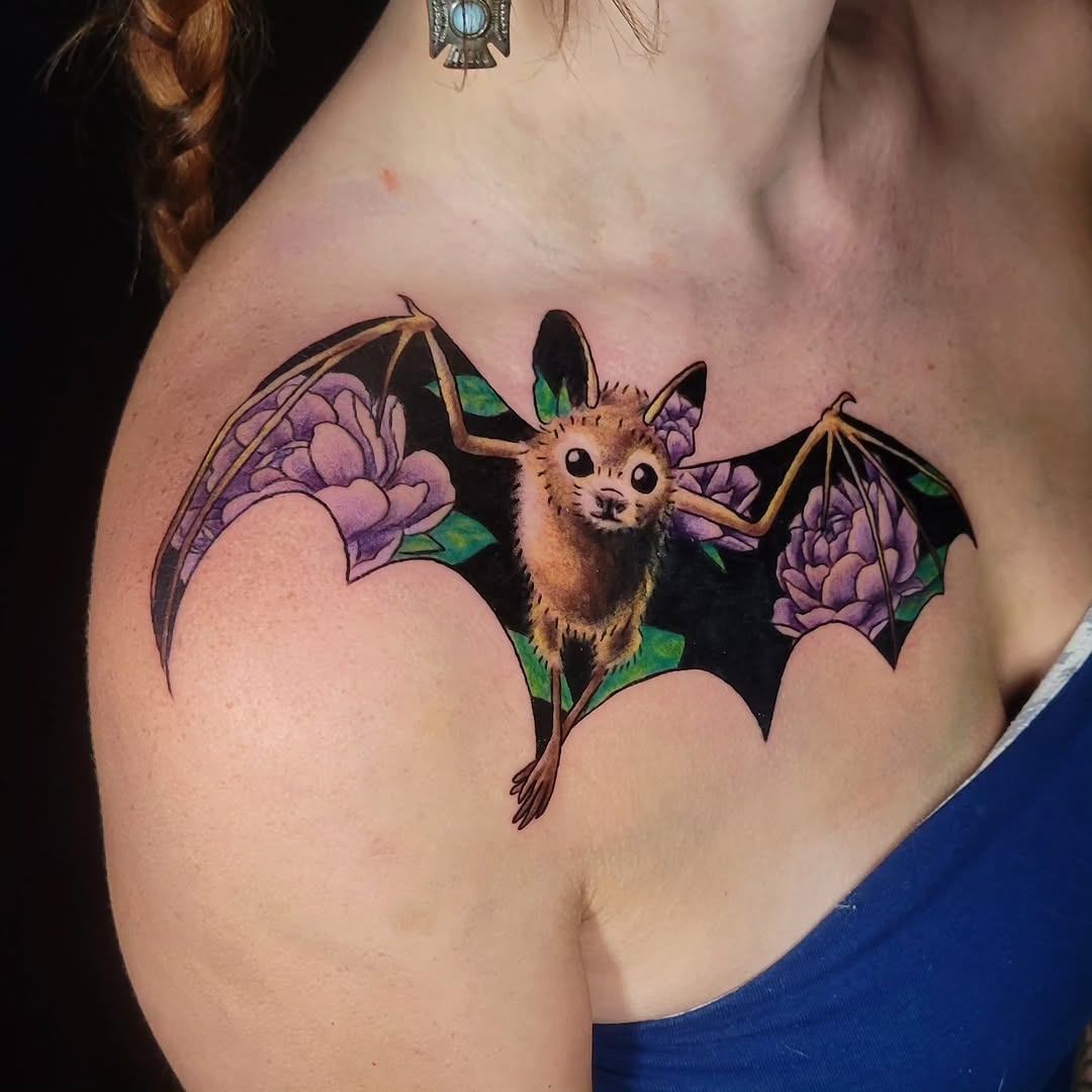 Bat with flowers fine line tattoo on the shoulder by Sarah Alba