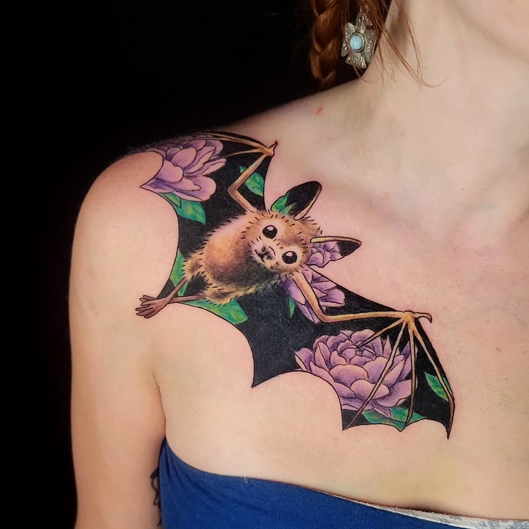 Bat with flowers fine line tattoo on the shoulder by Sarah Alba