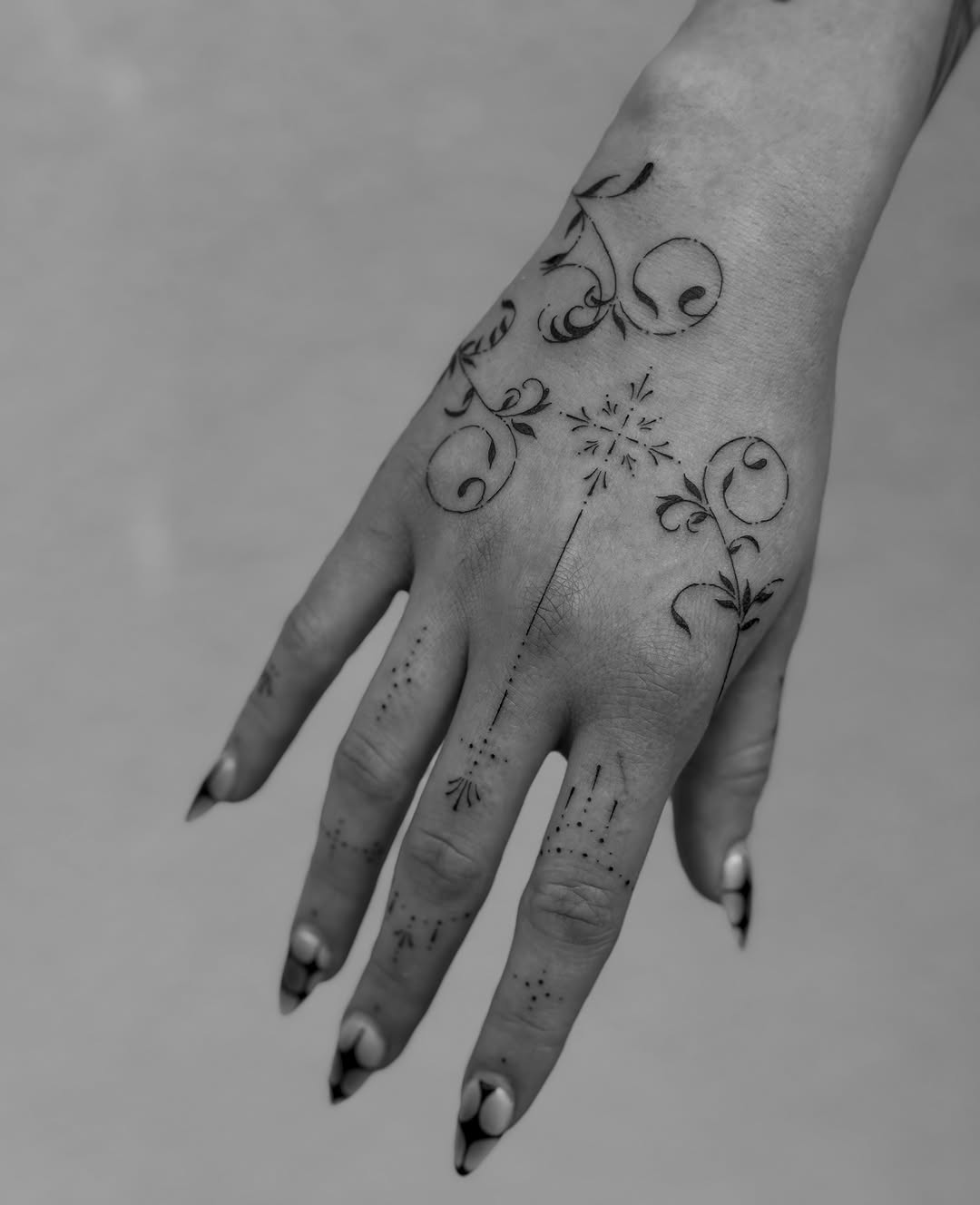 Ornamental floral design with dots ornamental tattoo on the hand by Abby Robinson