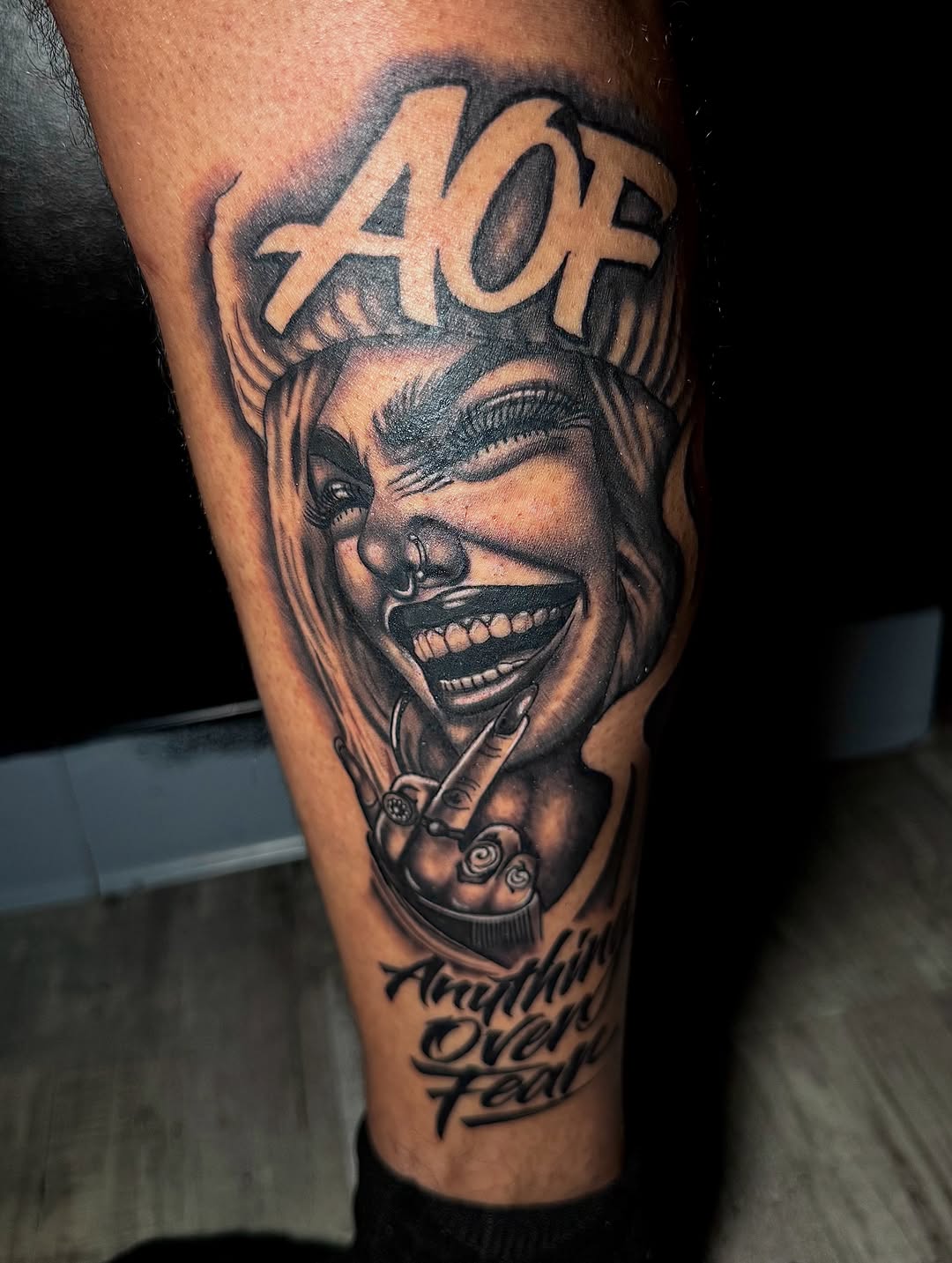 Woman with horns and text Chicano tattoo on the forearm by Left My Mark