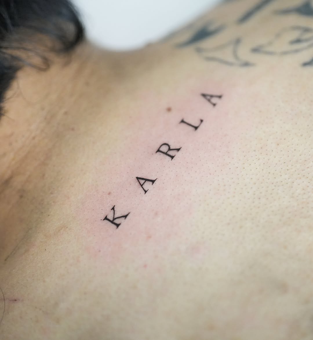 Name lettering lettering tattoo on the chest by Hery Anwar