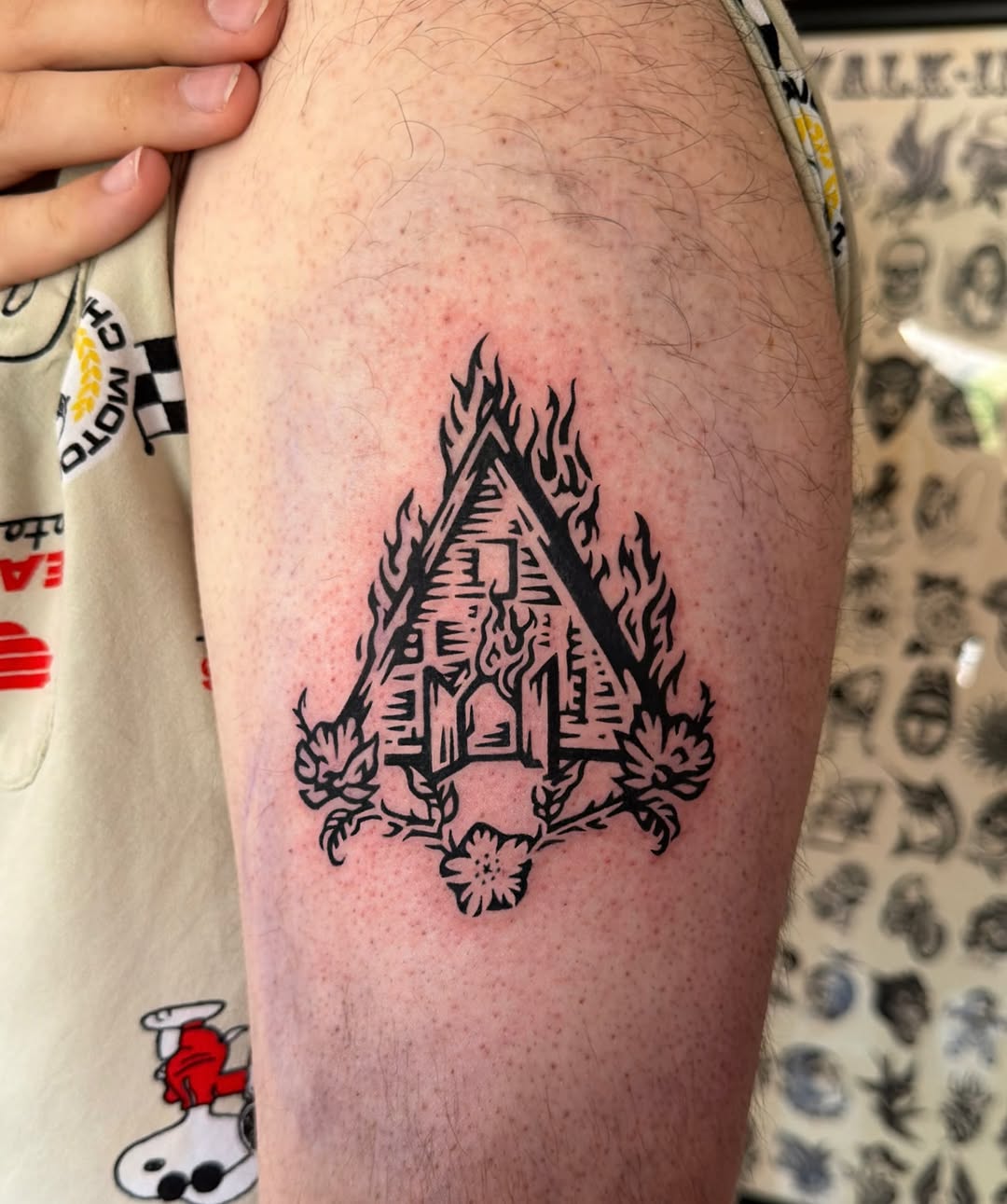 Burning house with flowers surrealism tattoo on the thigh by M