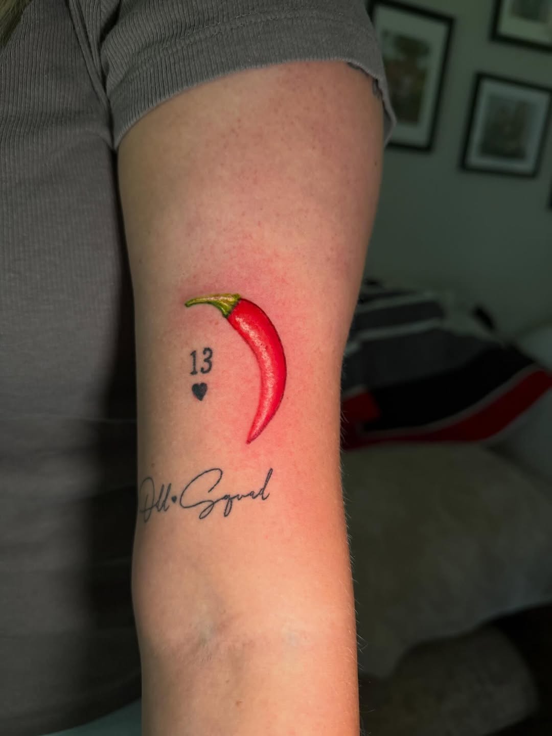 Chili pepper with numbers and script minimalist tattoo on the forearm by C.J.K. Roy