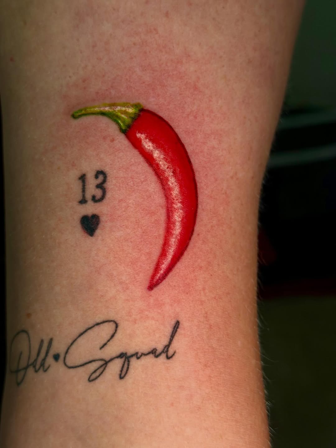 Chili pepper and script lettering American traditional tattoo on the forearm by C.J.K. Roy