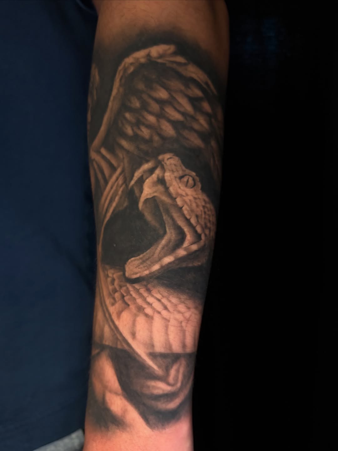 Snake with wings realism tattoo on the forearm by Bryce Presley, Mission, Kansas
