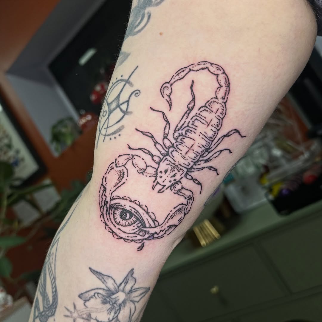 Scorpion and eye fine line tattoo on the forearm by Fleur ๐ฅ