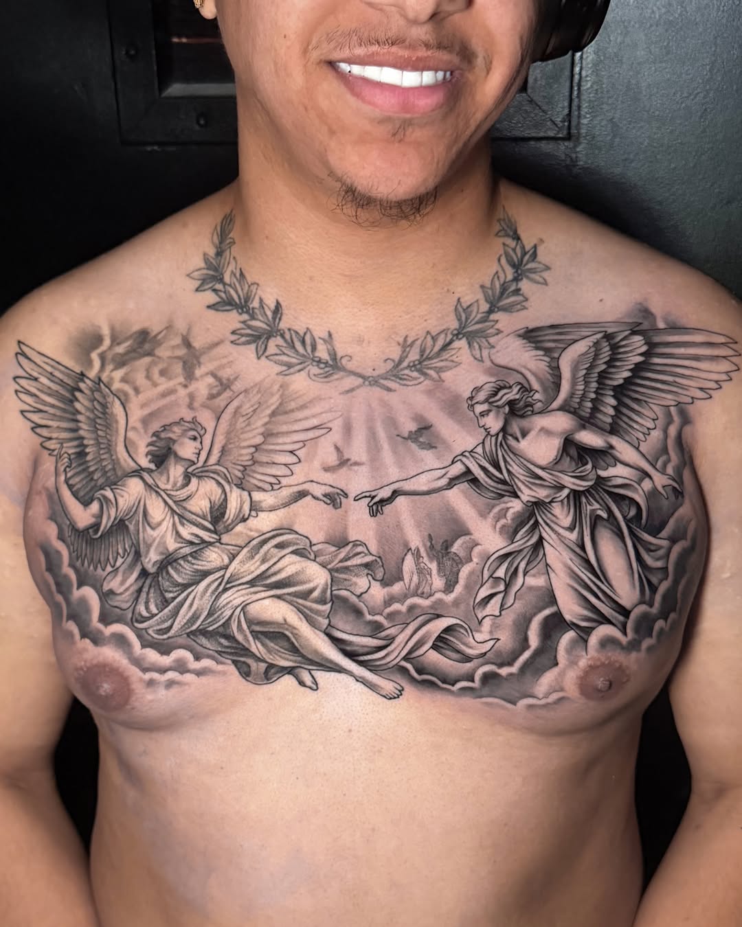 Angels reaching for each other realism tattoo on the chest by James Jurado