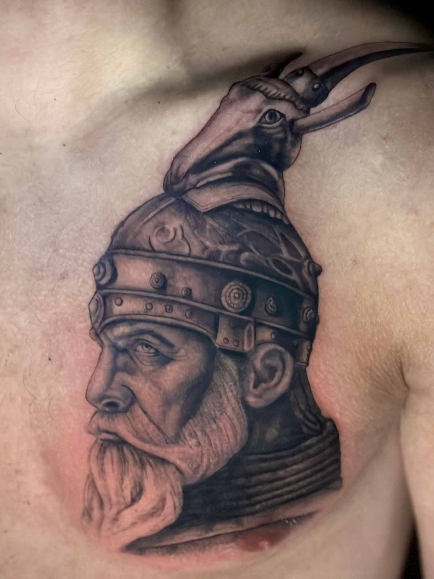 Viking warrior helmet realism tattoo on the chest by Jack