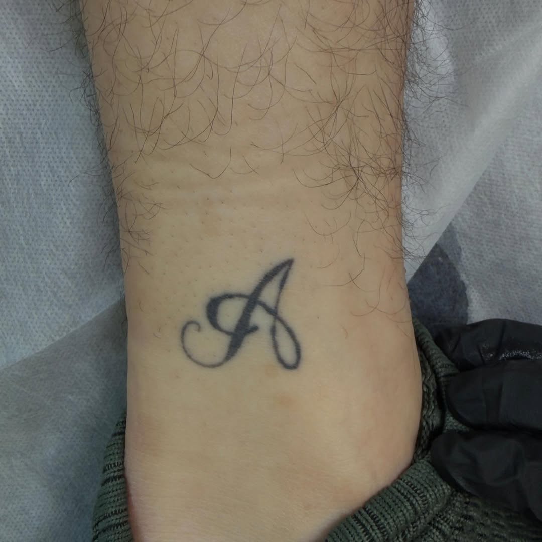 Letter A tribal tattoo on the forearm by Scar
