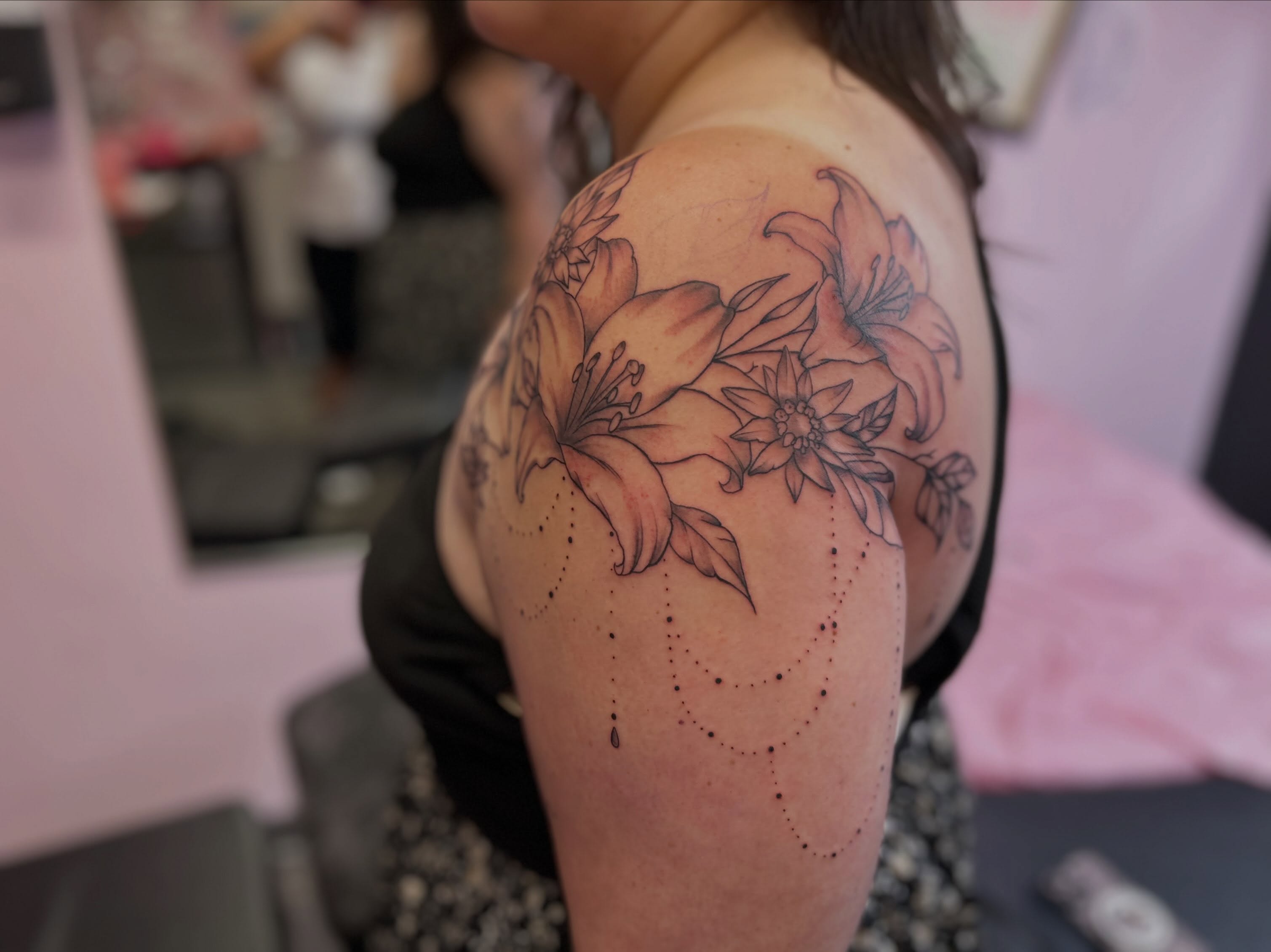 Lilies and edelweiss dotwork tattoo on the shoulder by Big Mar, Rocky Hill, Connecticut