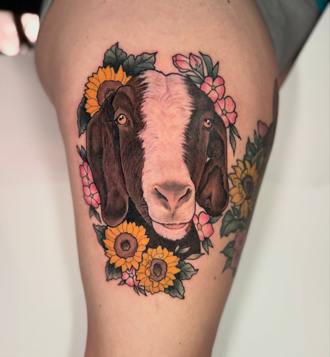 Goat with sunflowers realism tattoo on the thigh by Missi Blue