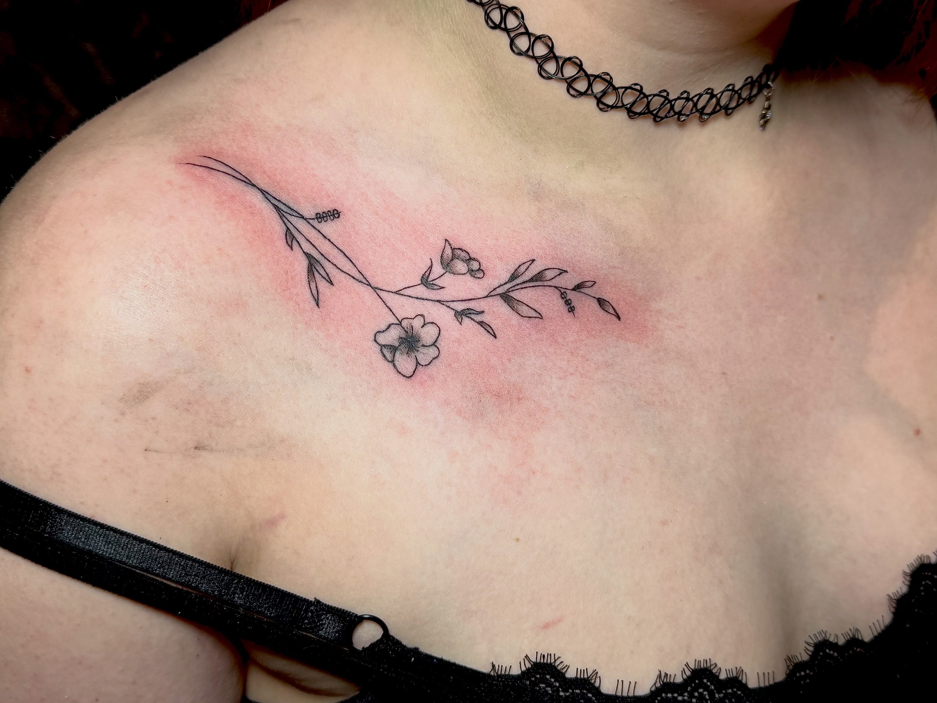 Flower branch fine line tattoo on the chest by Juliette :D