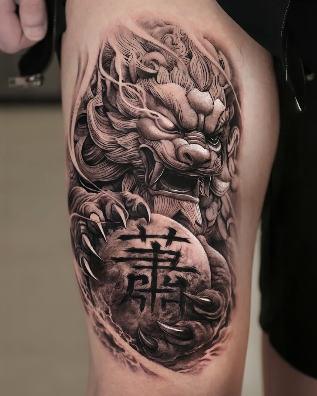 Foo dog with Chinese characters Japanese tattoo on the thigh by Reset tattoo