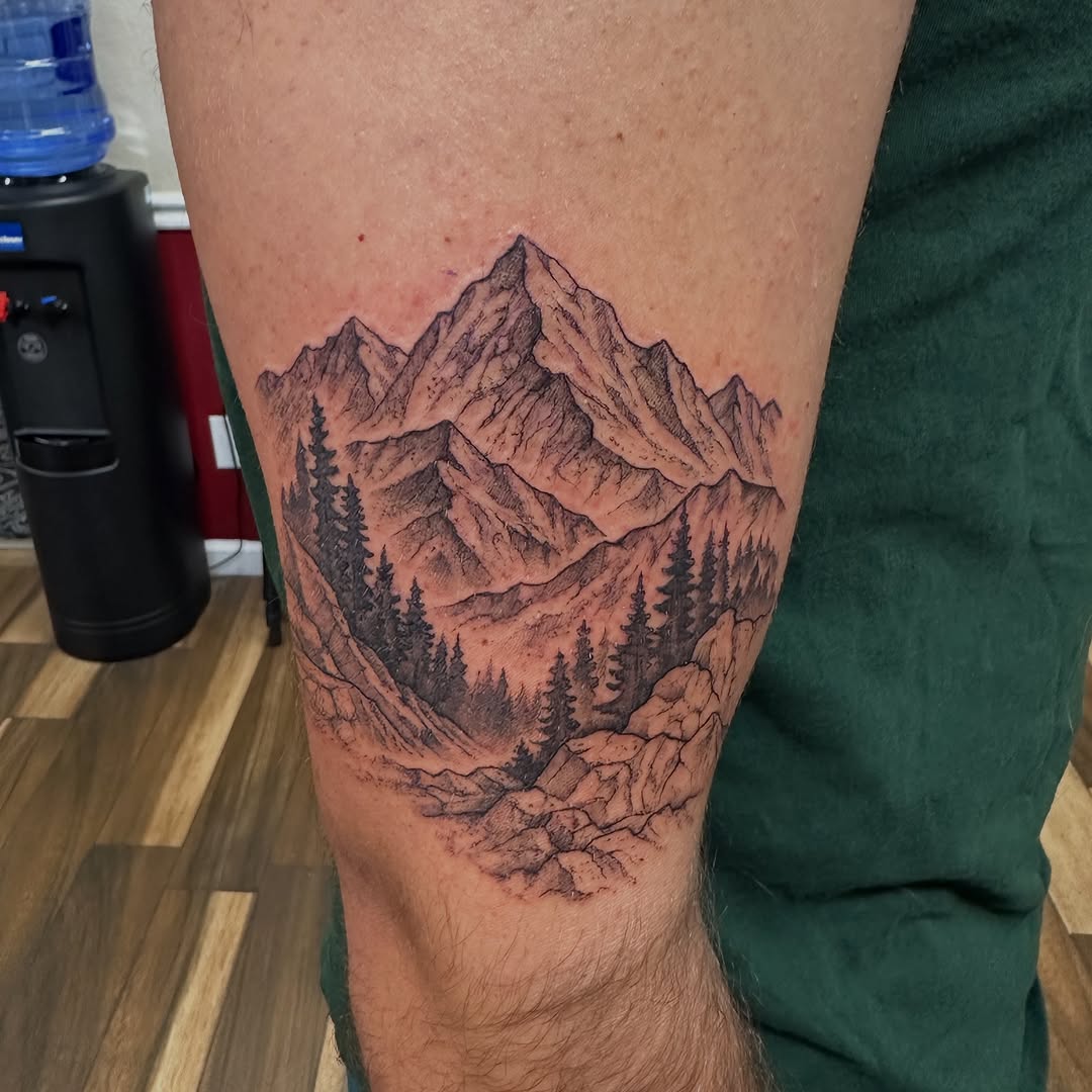 Mountain landscape with trees fine line tattoo on the thigh by Bosco Layne