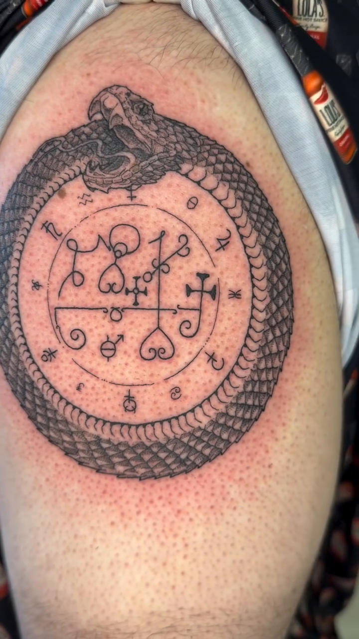 Ouroboros with sigils American traditional tattoo on the shoulder by Stvn Geyer, Urbandale, Iowa