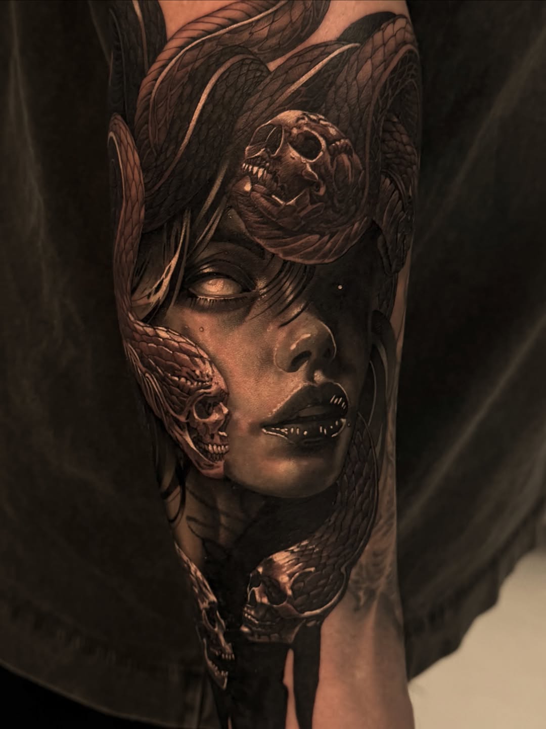 Medusa with snakes and skulls realism tattoo on the forearm by Vas - Tattoo New York NY