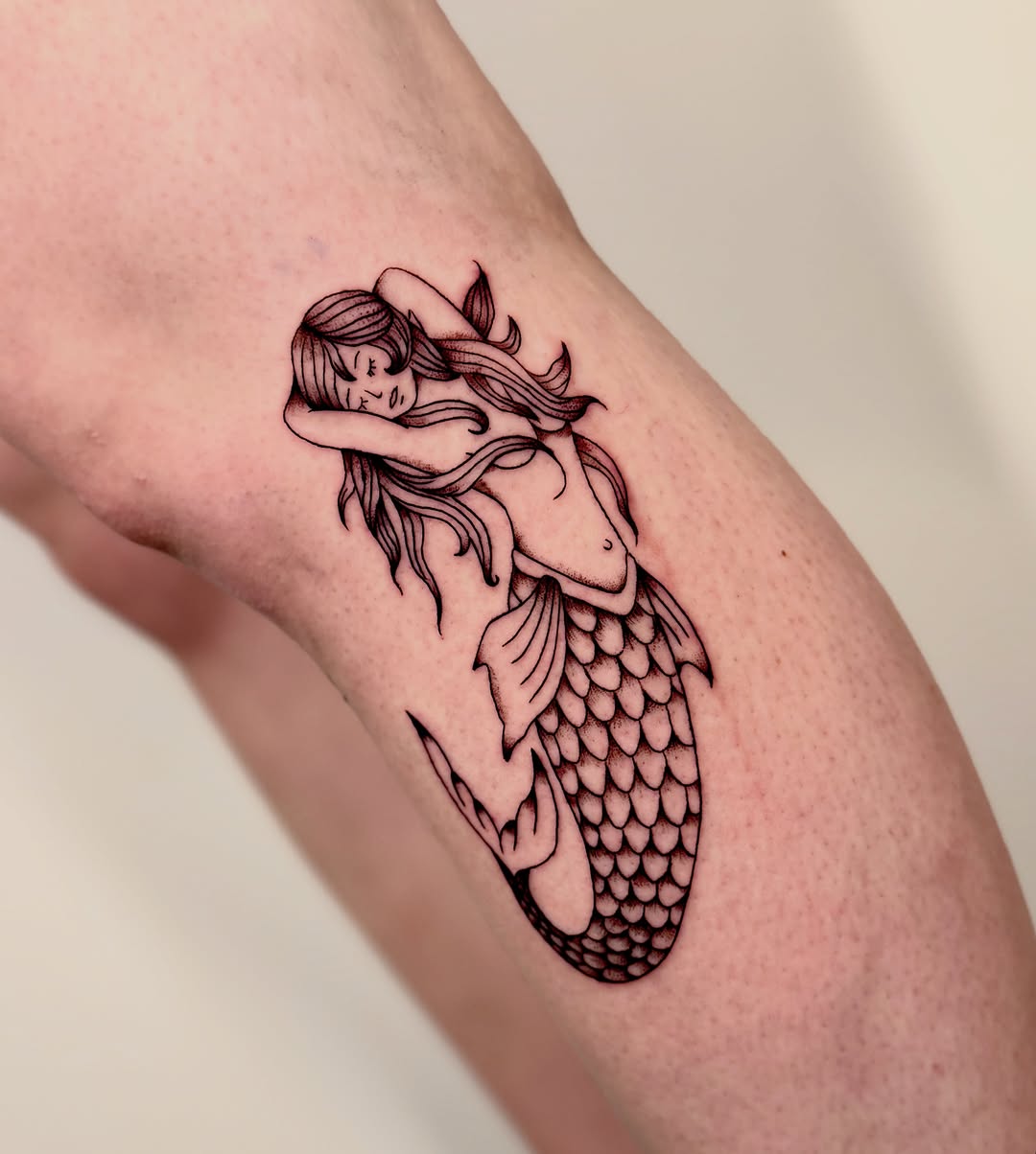 Mermaid fine line tattoo on the forearm by Orca