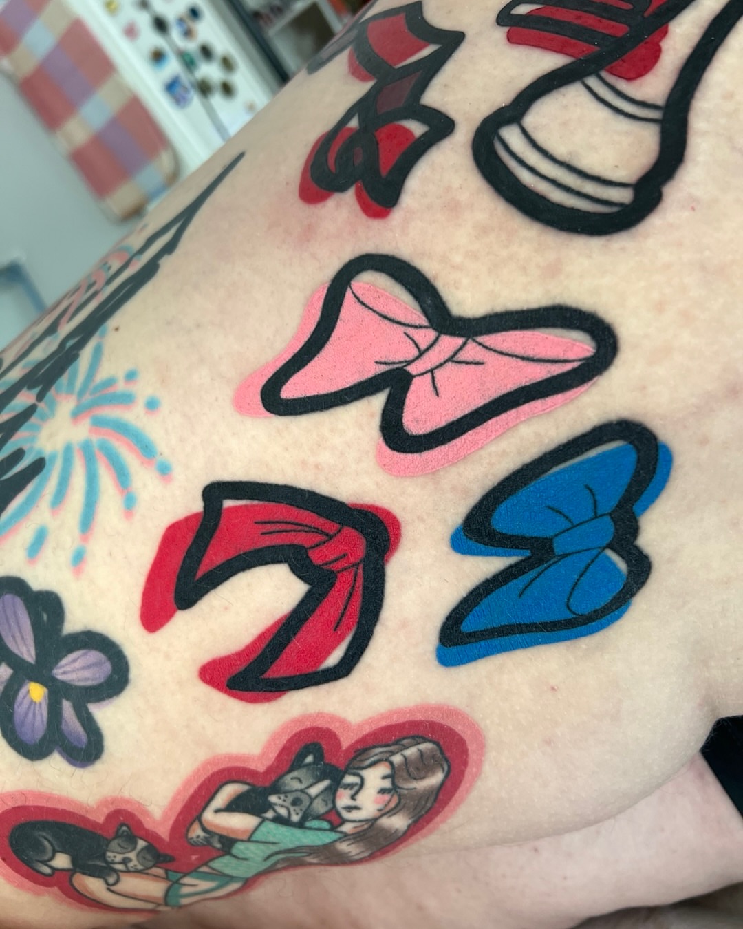 Bows American traditional tattoo on the upper arm by Tattoo Artist