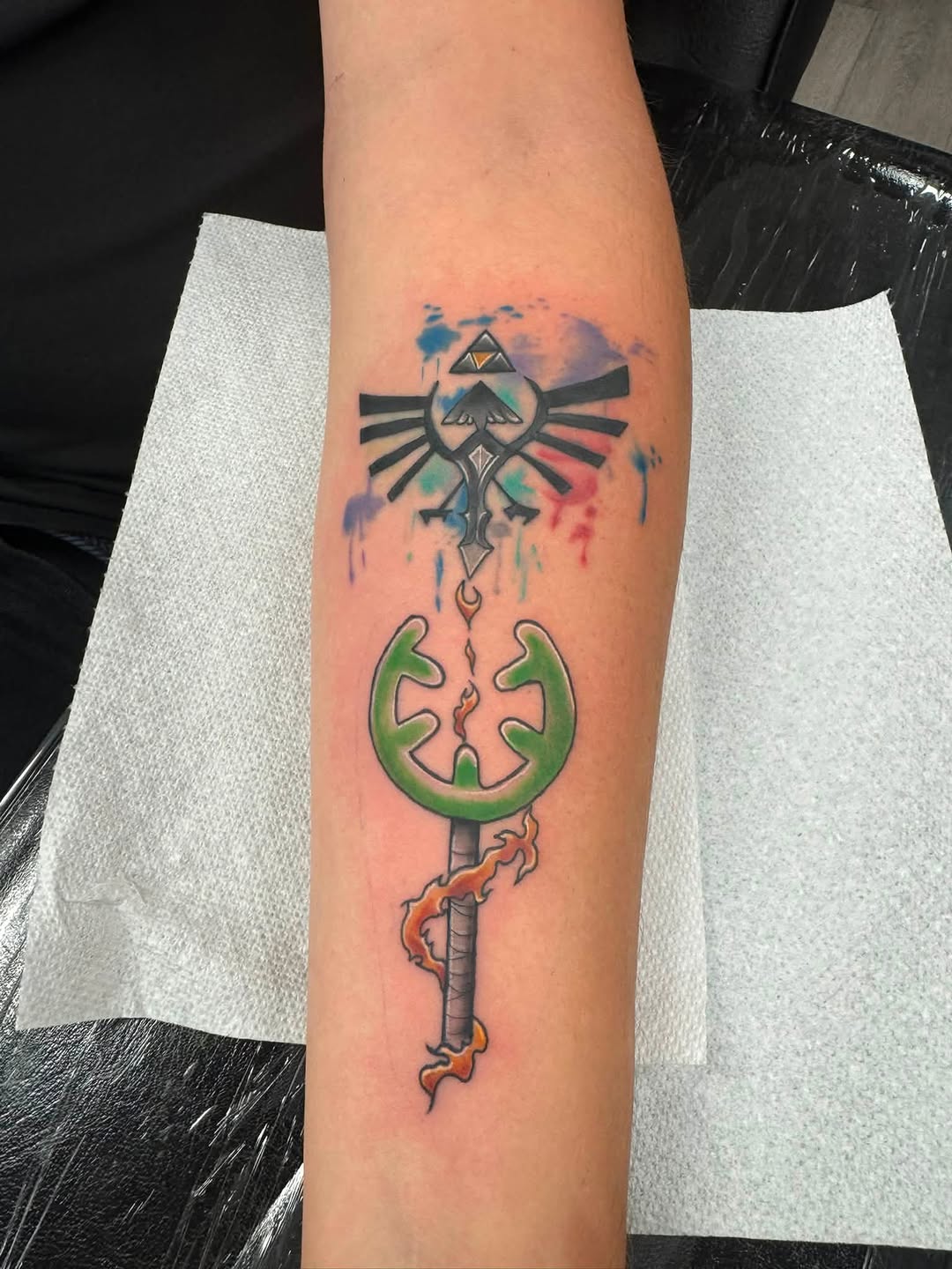 Zelda Triforce and Master Sword tattoo on the forearm by Israel Jacob Woehler