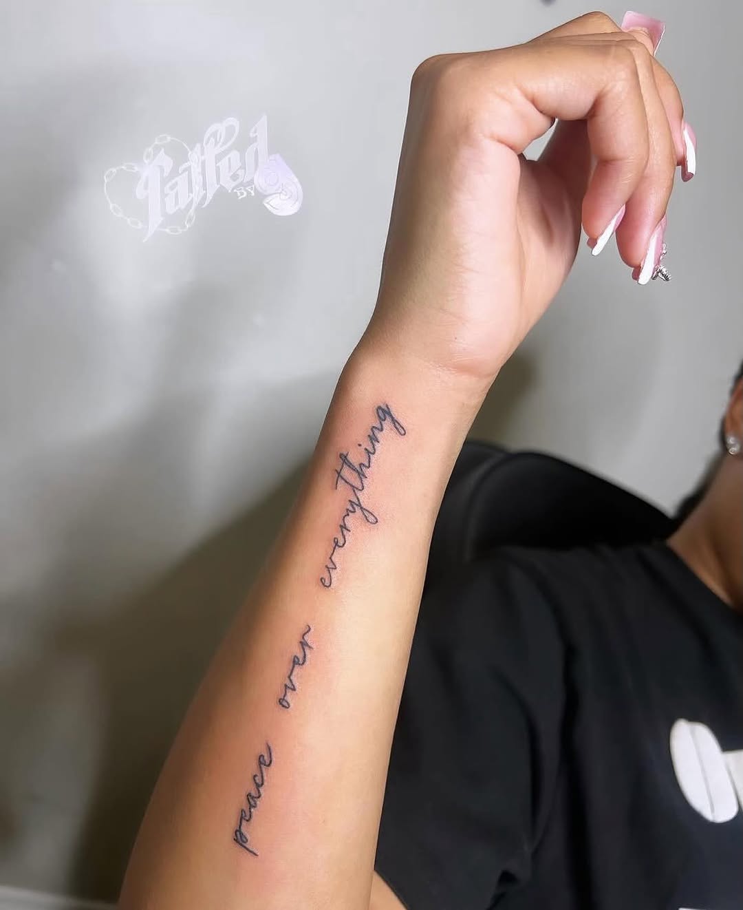 Peace over everything text lettering tattoo on the forearm by Dallas Tattoo Artist