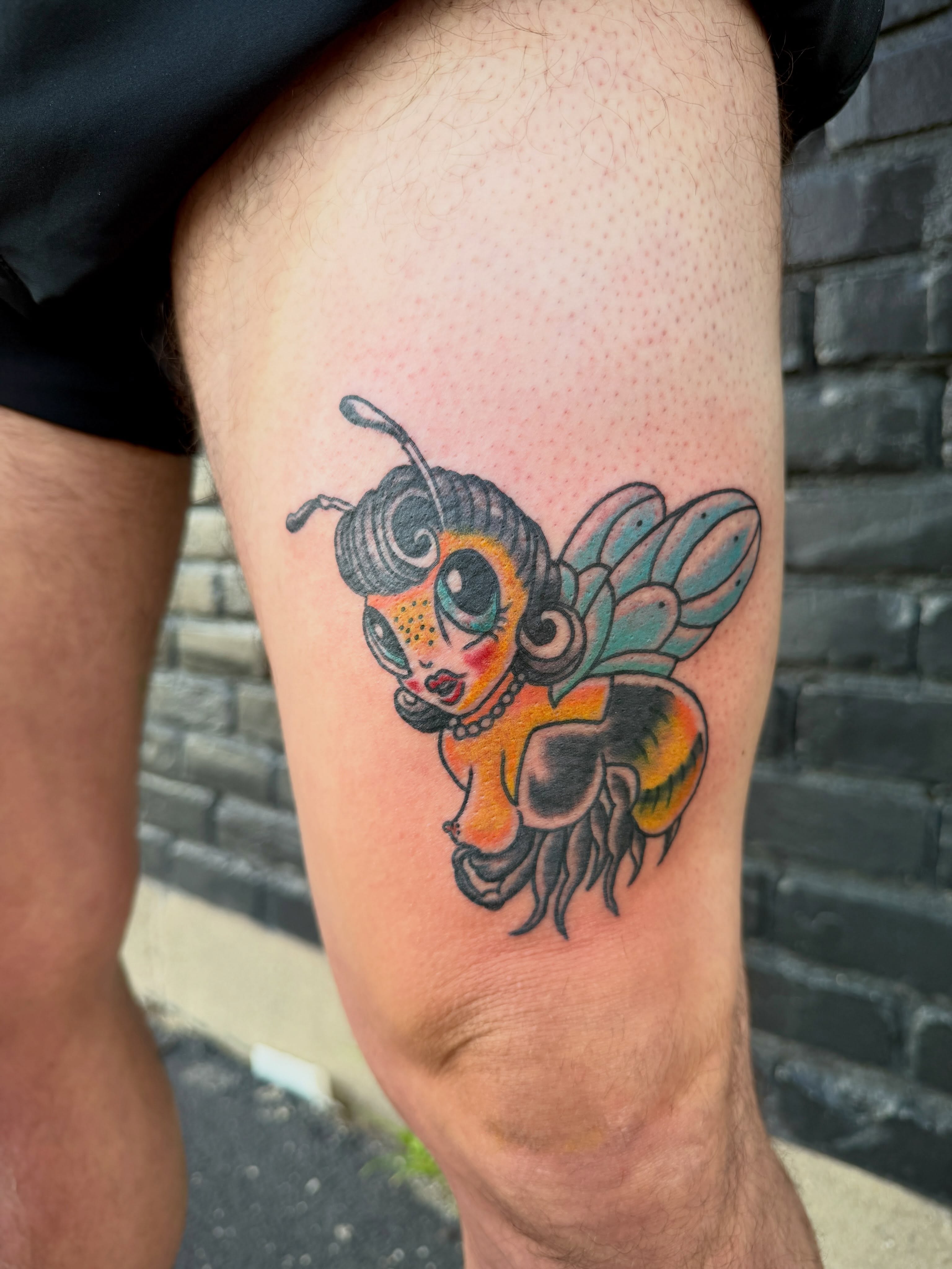 Bee American traditional tattoo on the thigh by Ali Calis