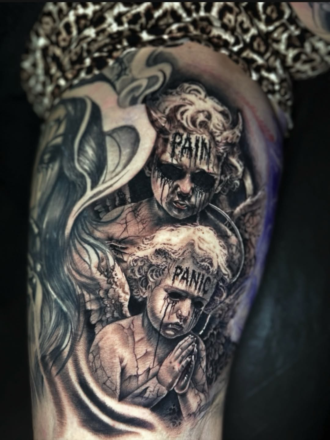 Cherubs with text realism tattoo on the forearm by C.J. Rued