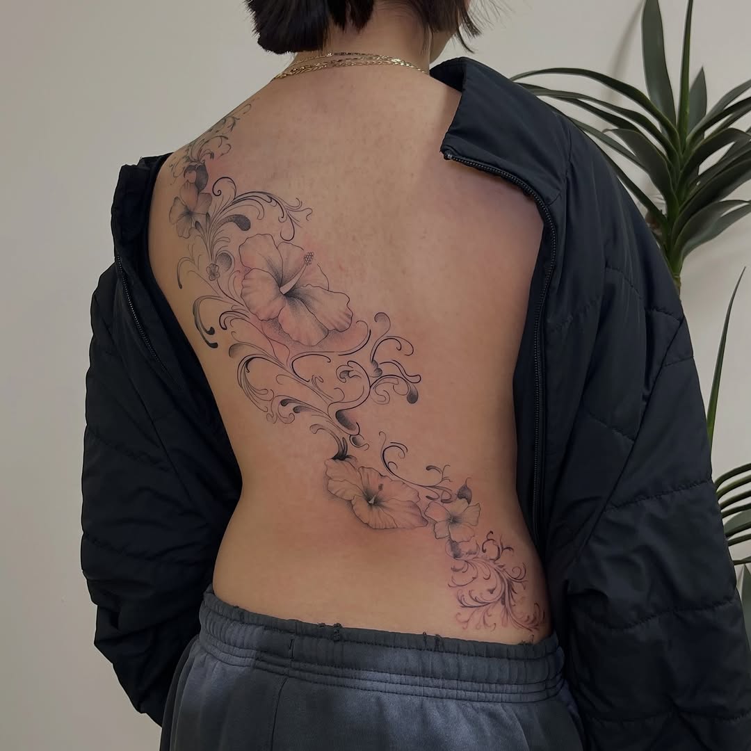 Hibiscus flowers and vines blackwork tattoo on the back by David