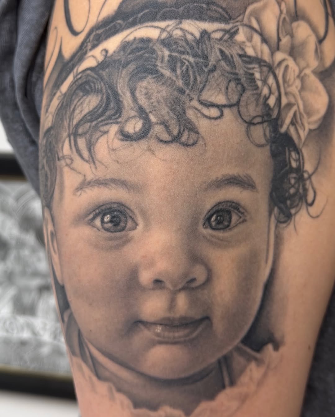 Baby portrait Chicano tattoo on the forearm by Richie Moreno lll