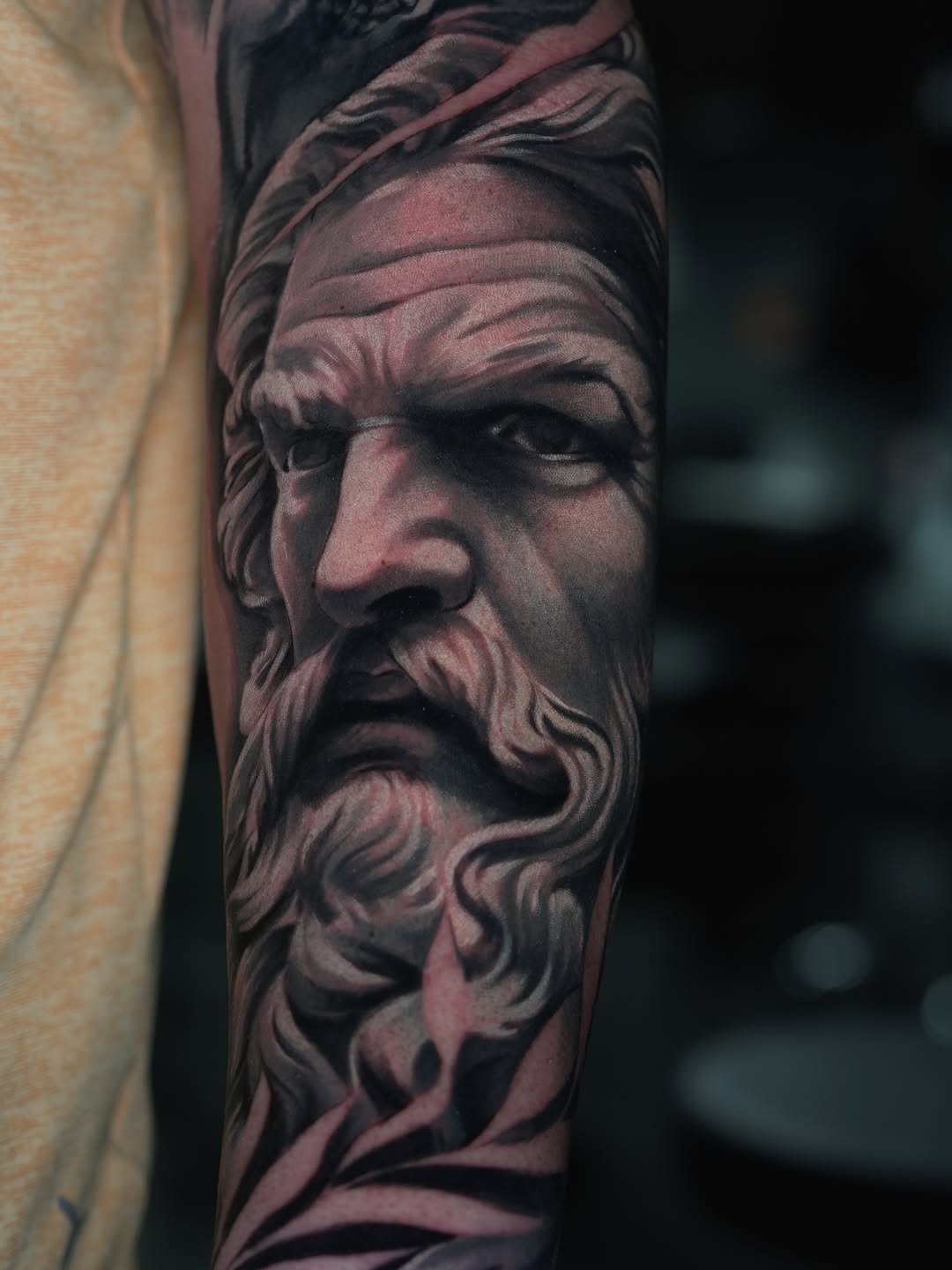Bust of a bearded man surrealism tattoo on the forearm by Andres García Baeza